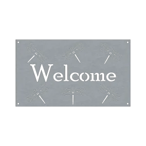 A rectangular steel sign with the word 'Welcome' in the center, framed by six laser-cut dragonflies in a symmetrical pattern. Each dragonfly is detailed with wings and a slender body. The sign has four small holes at each corner for easy mounting. The steel appears smooth and has a subtle sheen, contributing to its rustic charm.